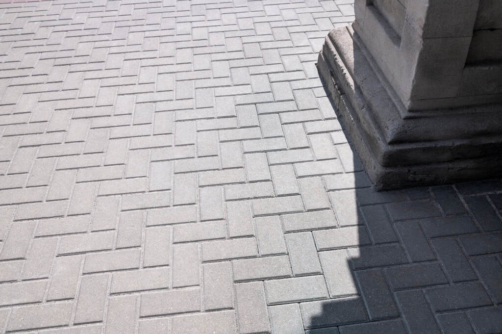 Gray concrete pavers on courtyard grounds for a pavement background